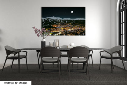 a room with a table and chairs and a painting on the wall