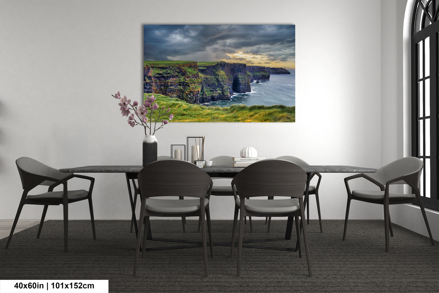 a dining room table with chairs and a painting on the wall