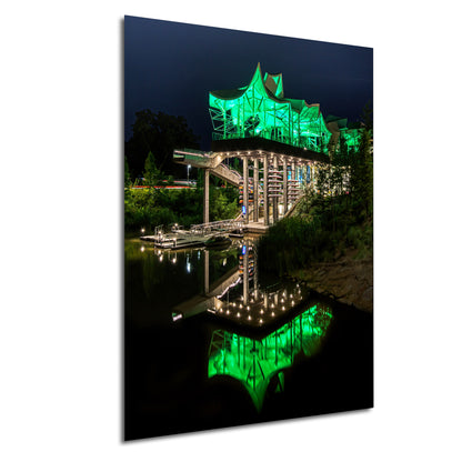 a lit up bridge over a body of water
