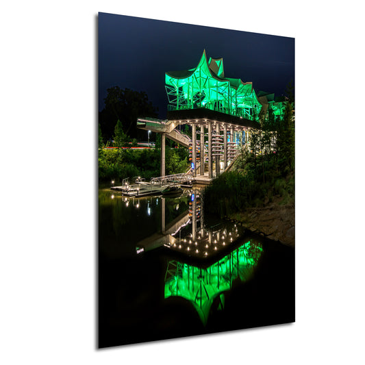 a lit up bridge over a body of water