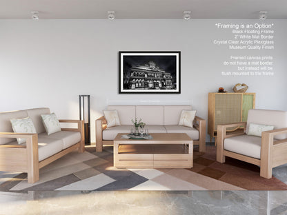 a living room filled with furniture and a painting on the wall