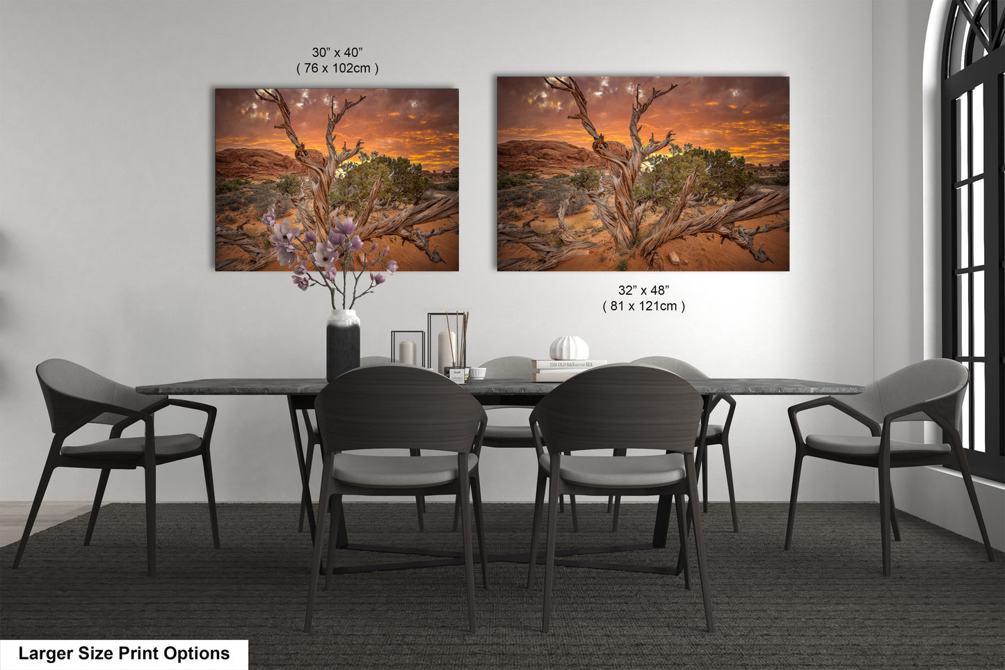 a dining room table with four chairs and a painting on the wall