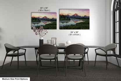 a dining table with four chairs and a vase of flowers