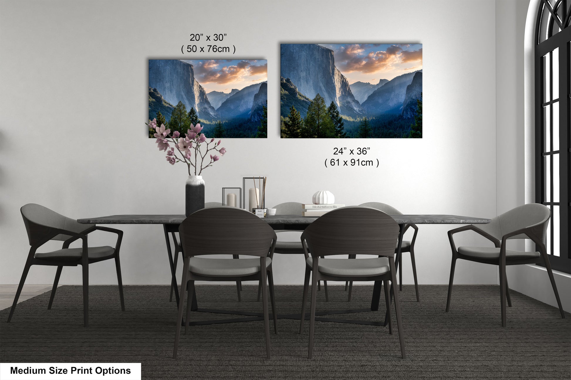 a dining table with four chairs and a vase with flowers