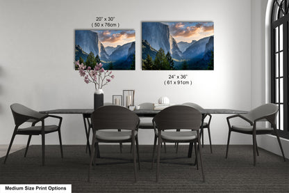 a dining table with four chairs and a vase with flowers
