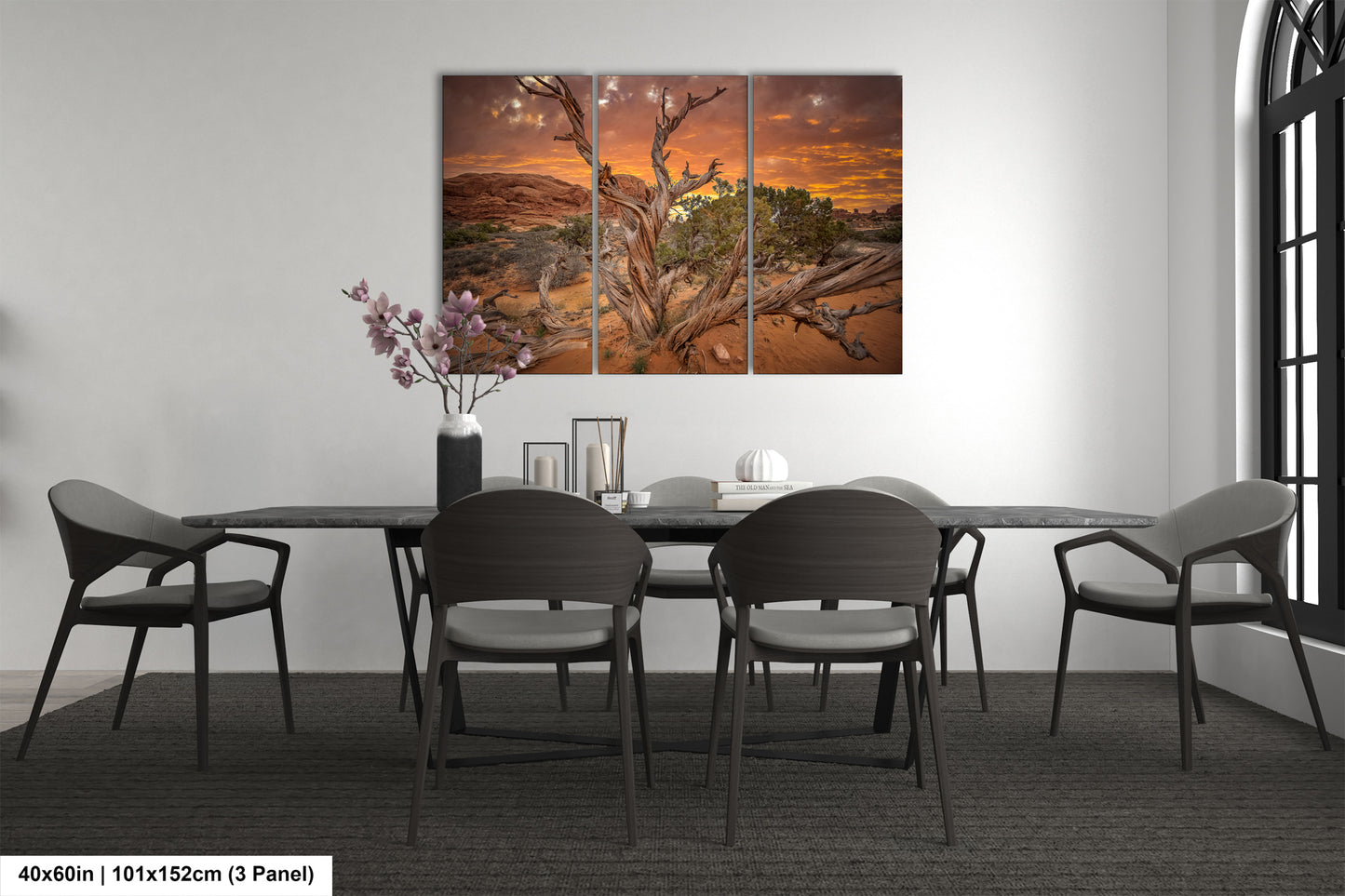 a dining room table with four chairs and a painting on the wall