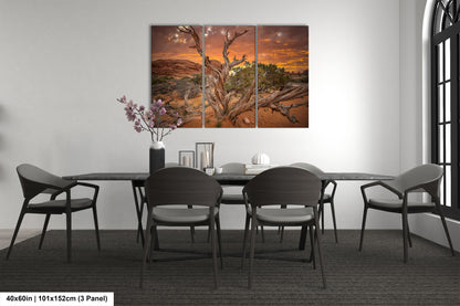 a dining room table with four chairs and a painting on the wall