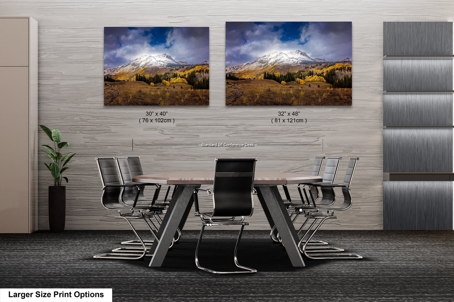 a dining room table with chairs in front of a wall with two pictures of mountains