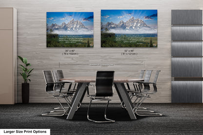 a dining room table with chairs in front of two pictures of mountains