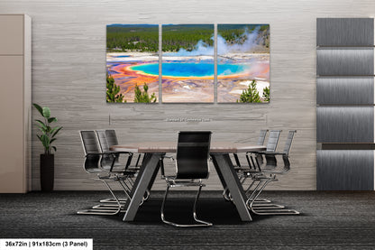 a dining room with a table and chairs with a view of a geyser