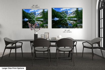 a dining table with four chairs and a vase with flowers