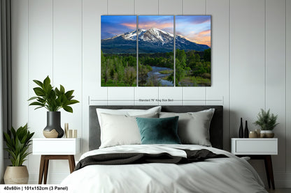 a bedroom with a large bed and a mountain in the background
