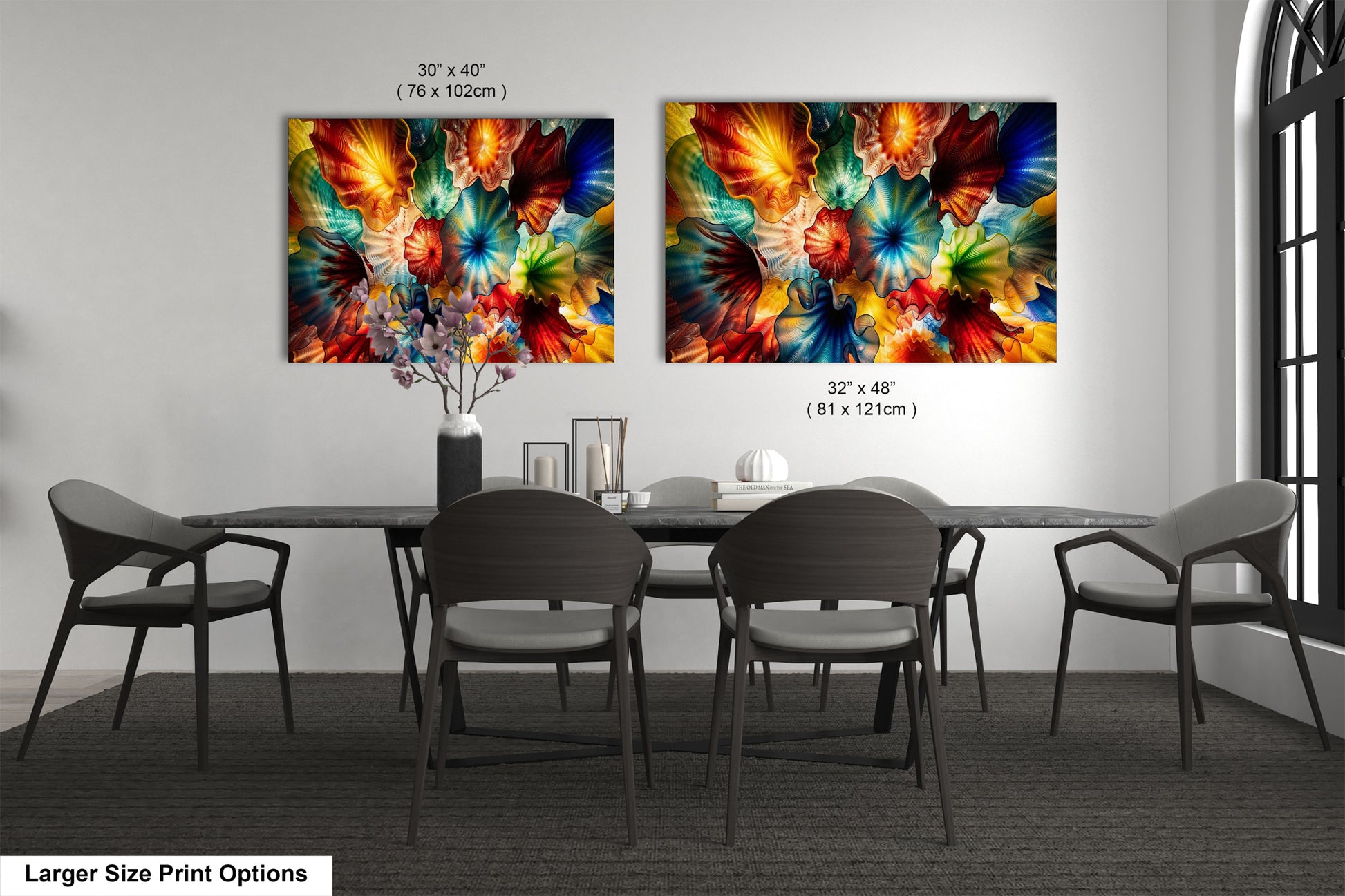 two large paintings of colorful flowers hanging on a wall above a dining table with chairs.