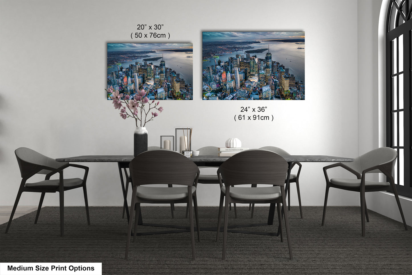 a dining room table with four chairs and a vase with flowers
