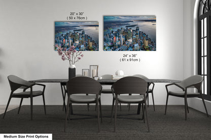 a dining room table with four chairs and a vase with flowers