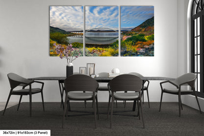 a dining room table with four chairs and a painting on the wall