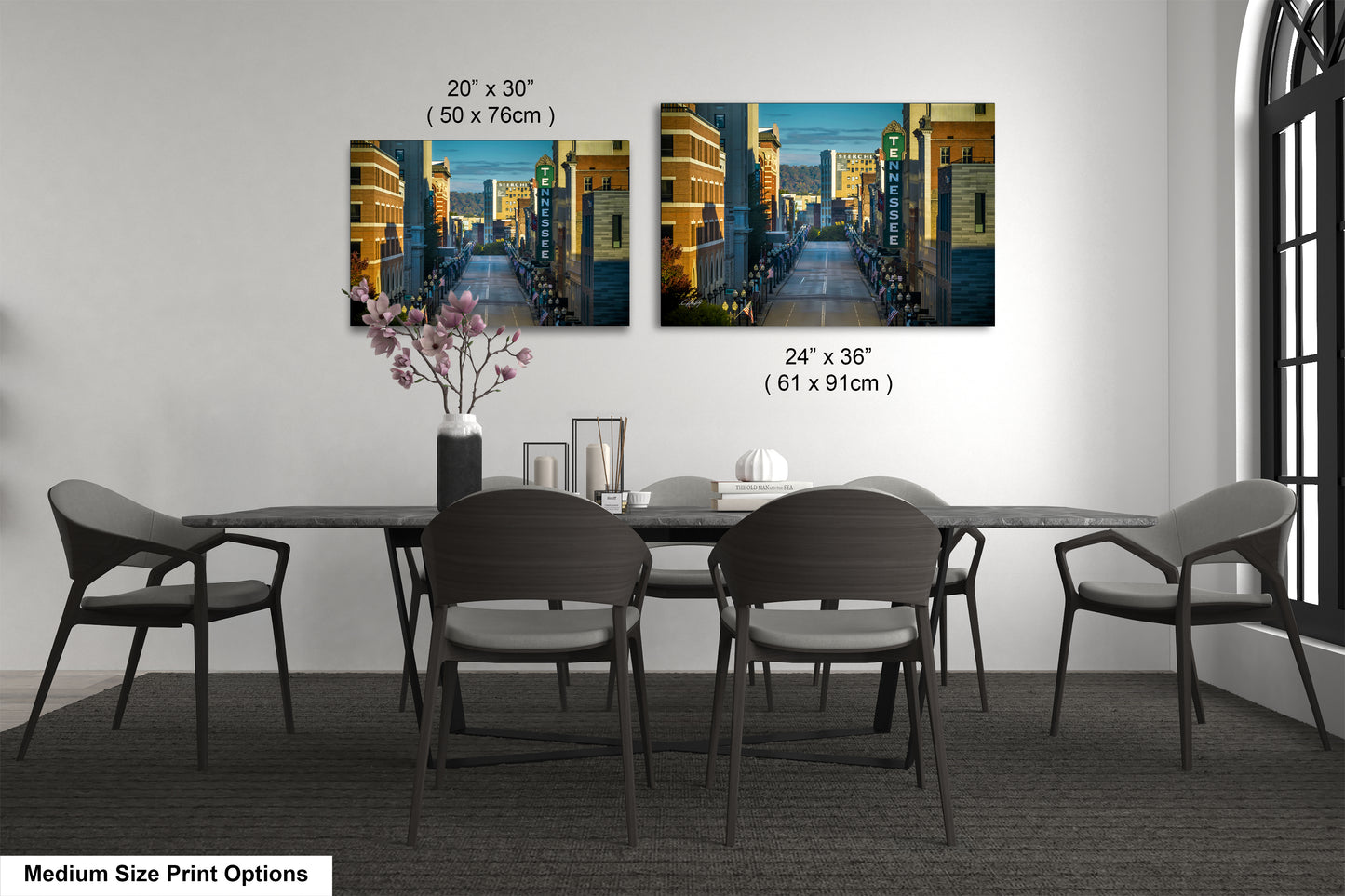 a dining table with four chairs and a vase of flowers
