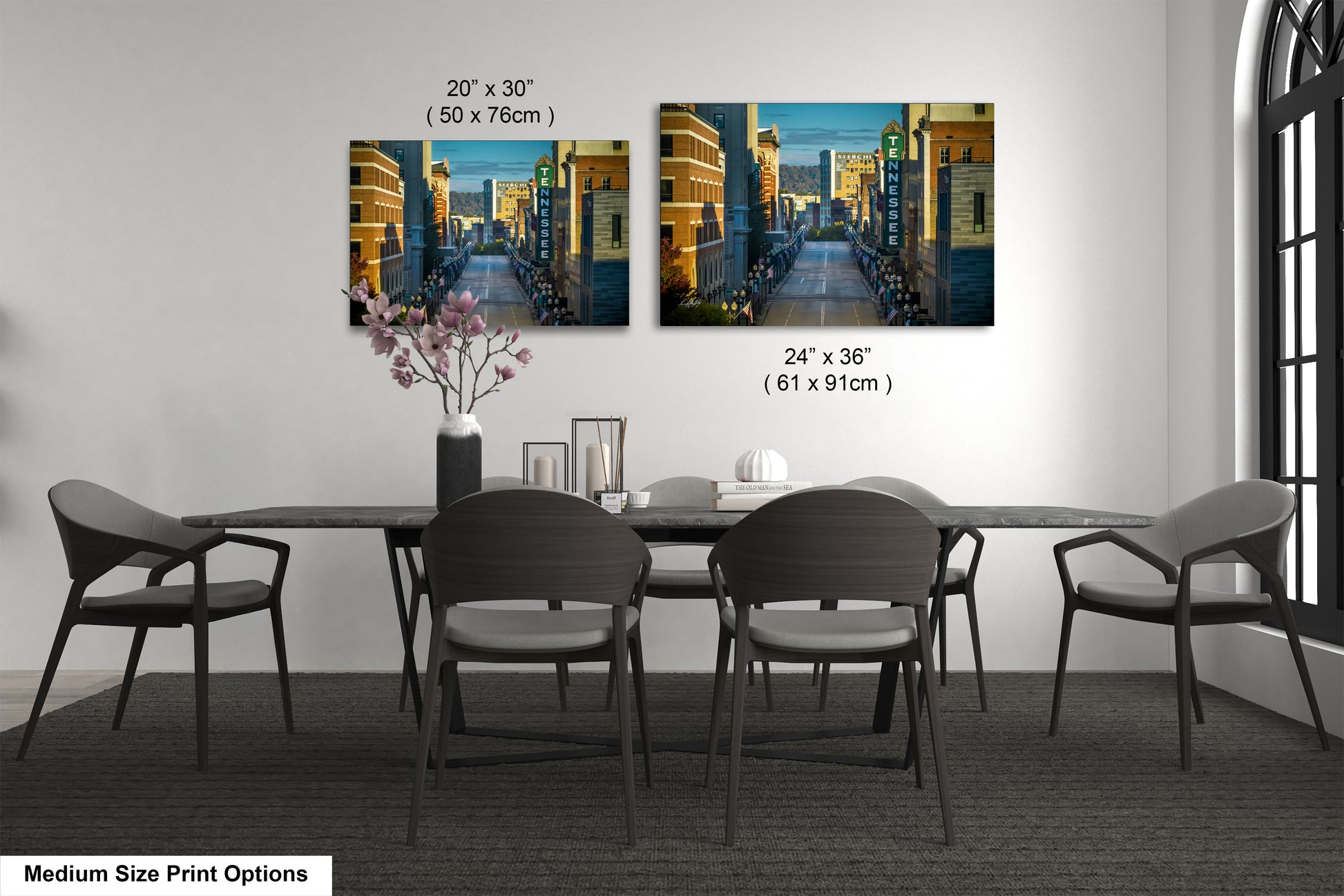 a dining table with four chairs and a vase of flowers