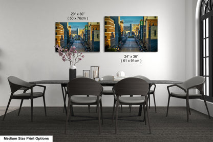 a dining table with four chairs and a vase of flowers