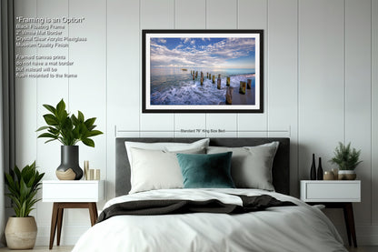 a bedroom with a bed and a picture hanging on the wall