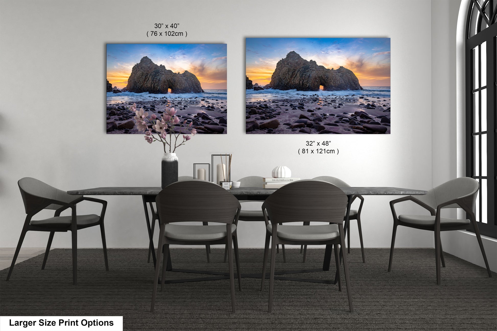 a dining room table with four chairs and two pictures on the wall