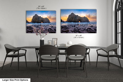 a dining room table with four chairs and two pictures on the wall