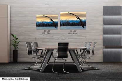 a dining room table with chairs and two pictures on the wall