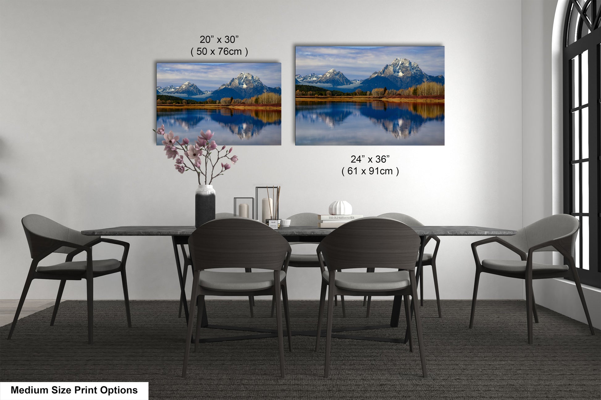 a dining table with four chairs and a vase of flowers