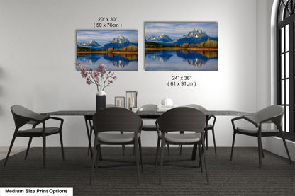 a dining table with four chairs and a vase of flowers