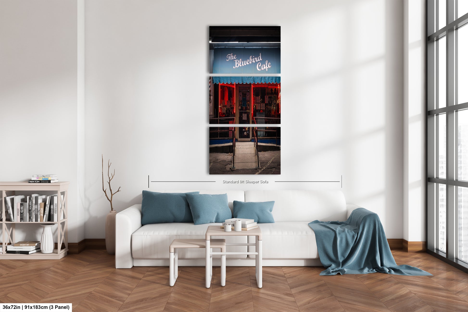 a white couch sitting in a living room next to a window