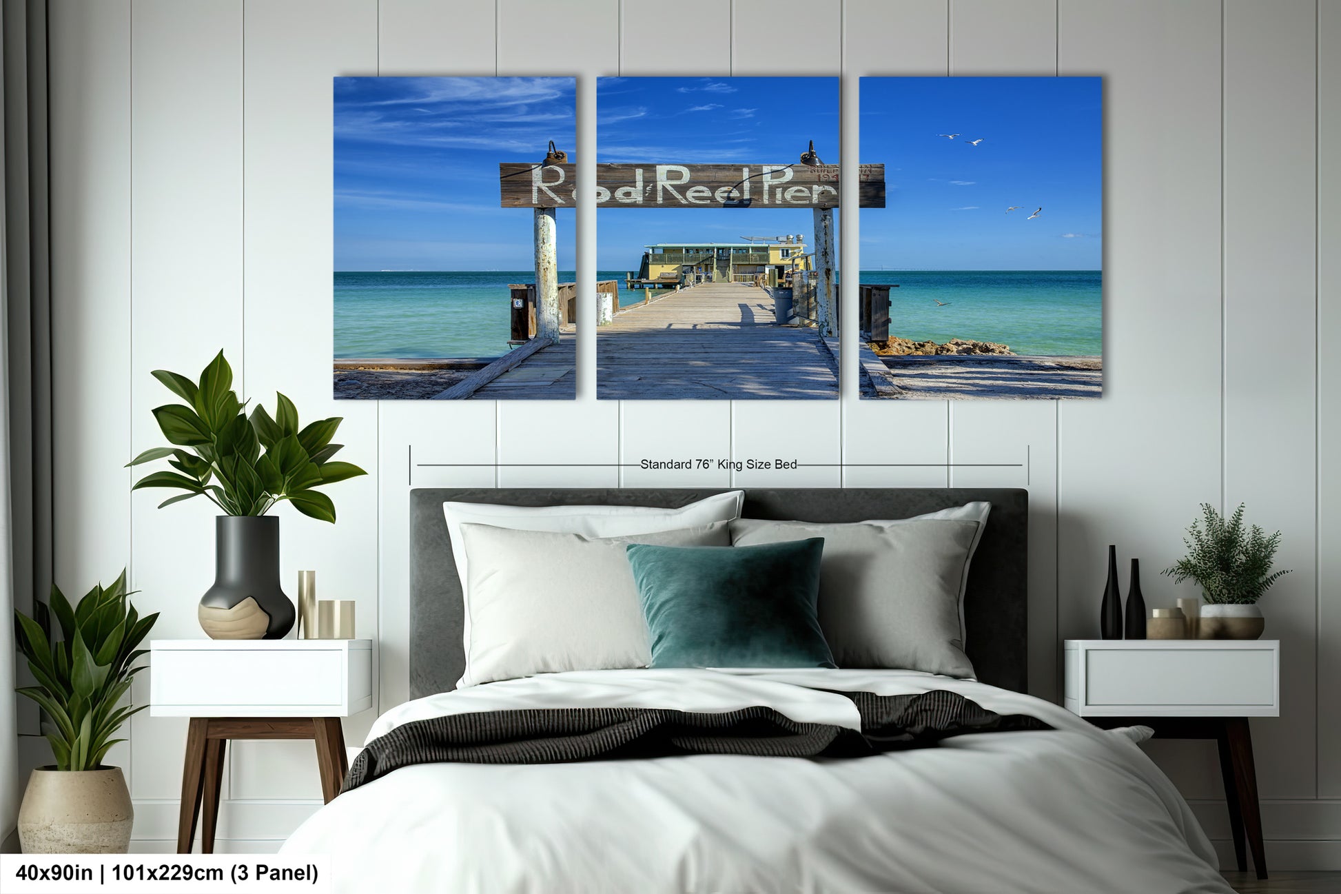 a bed room with a neatly made bed and two paintings on the wall
