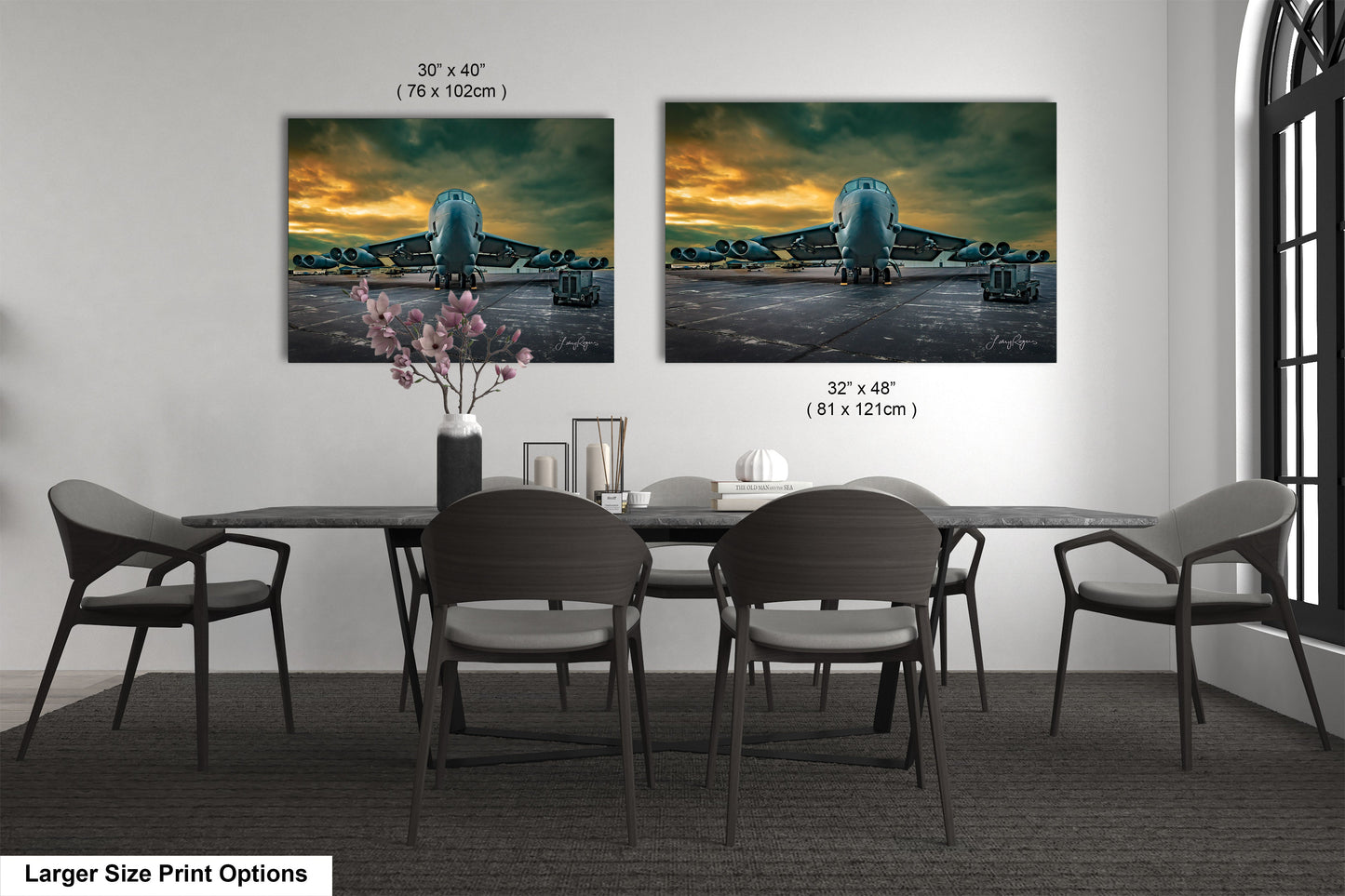 a dining table with four chairs and a vase of flowers