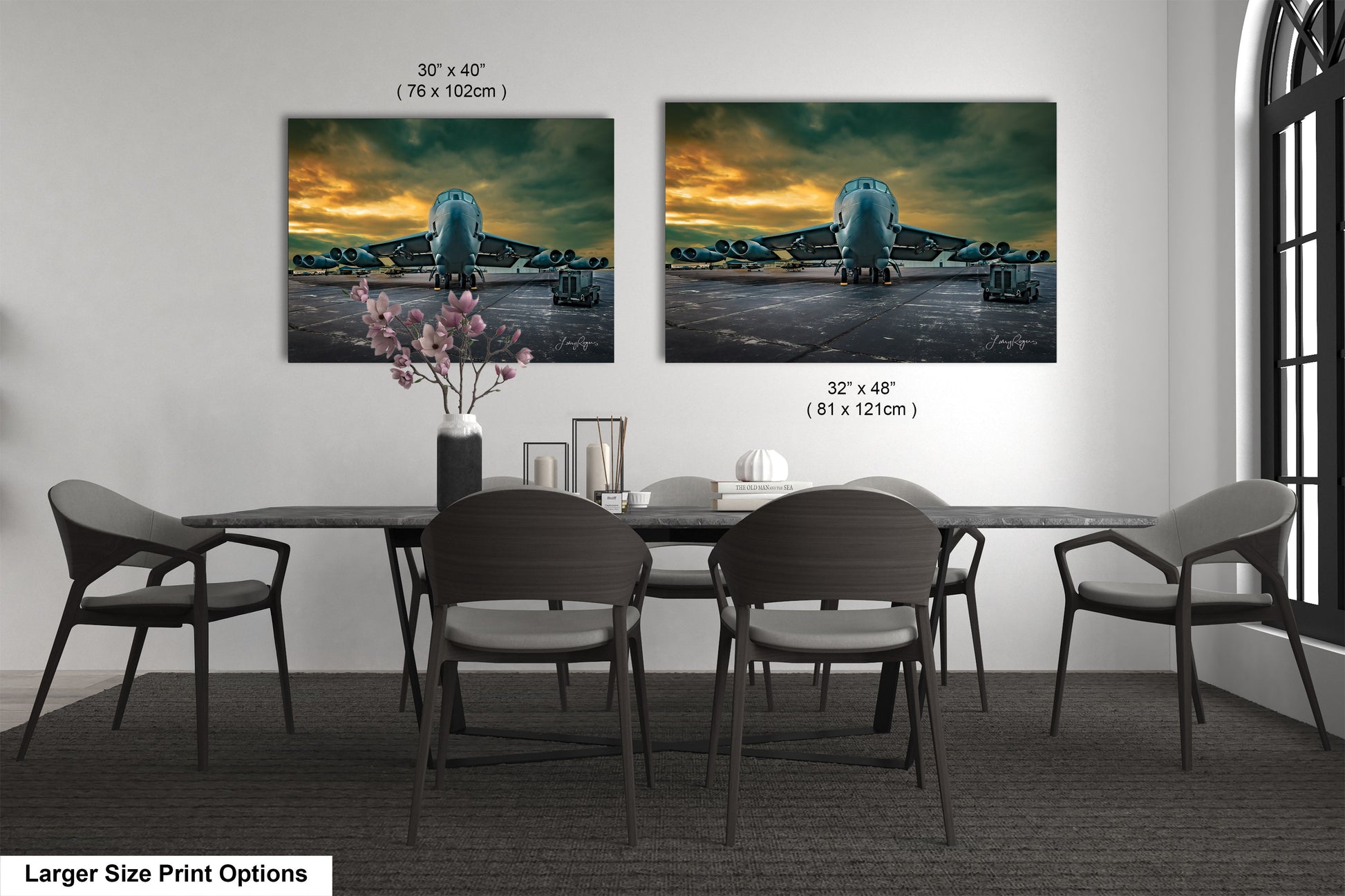 a dining table with four chairs and a vase of flowers