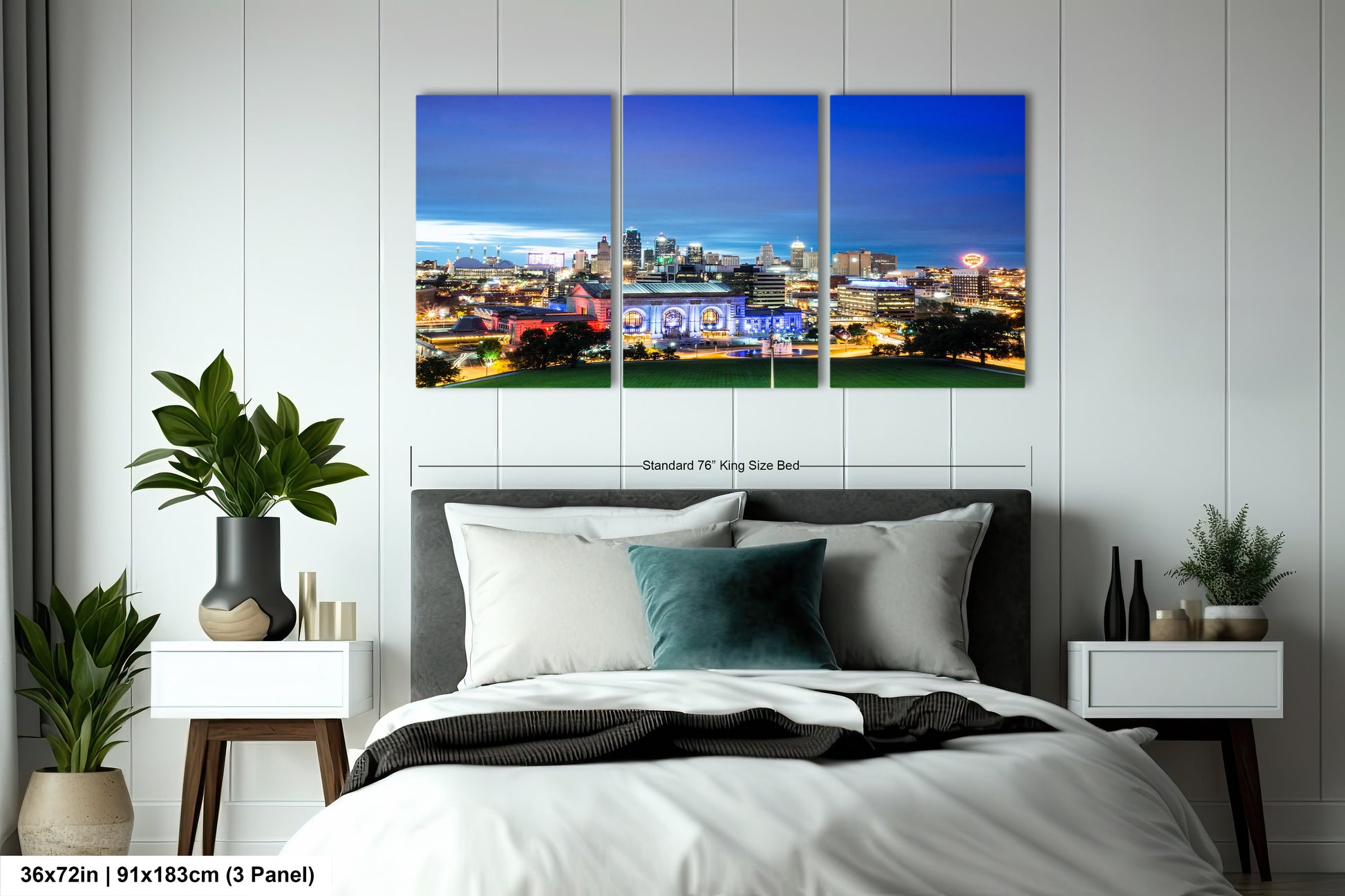 a bedroom with a bed and a night view of a city