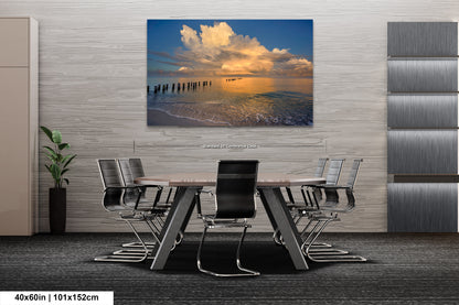 a dining room table with chairs and a painting on the wall