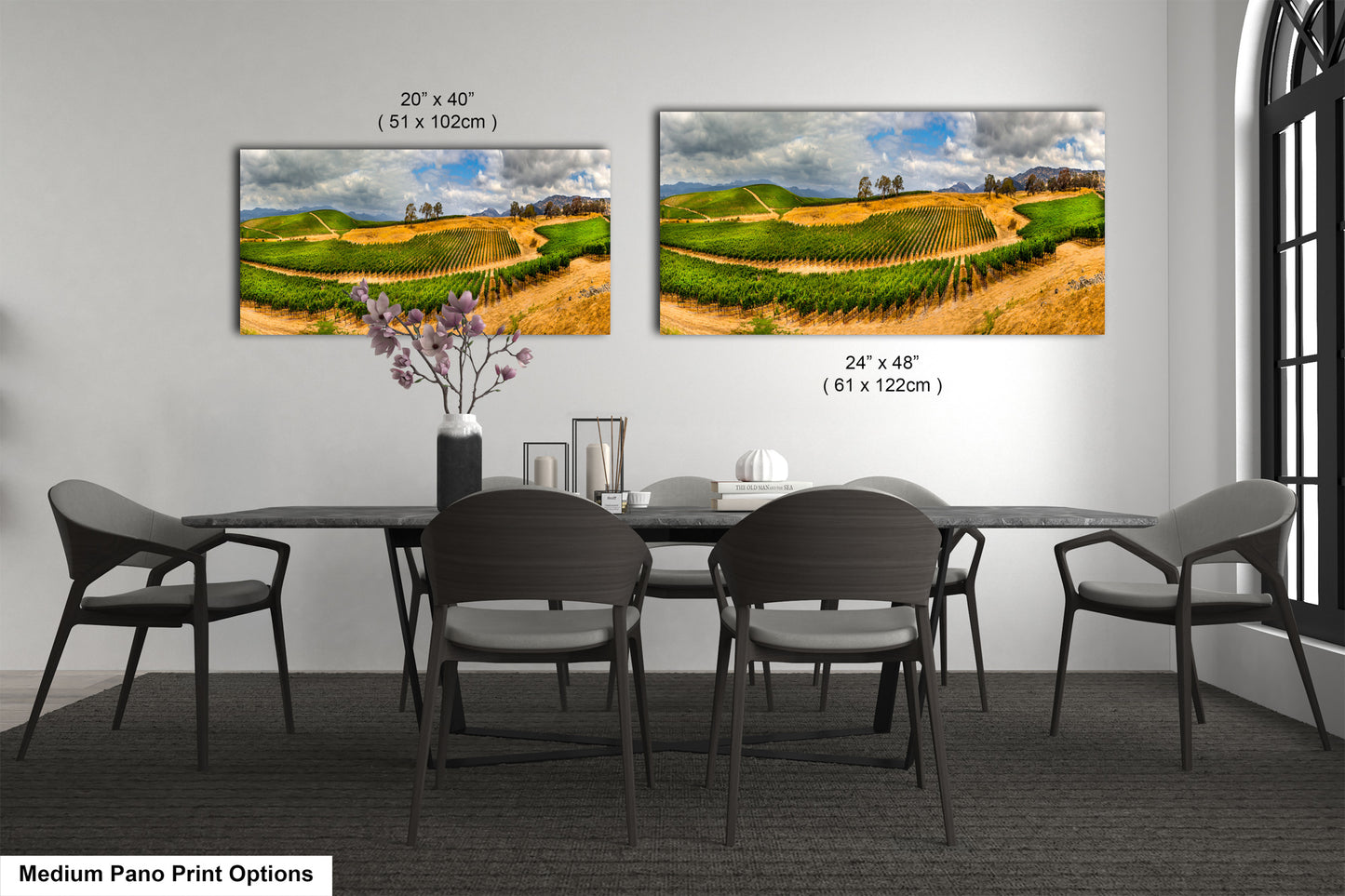 a dining room table with four chairs and two pictures on the wall