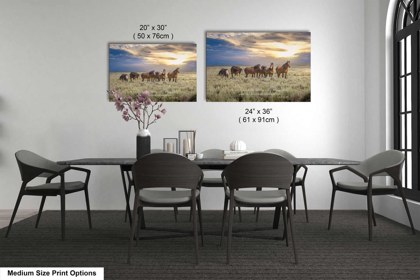 a dining room table with four chairs and two pictures of horses on the wall