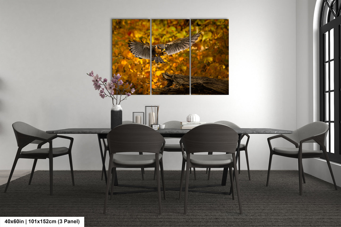 a dining room table with chairs and a painting on the wall
