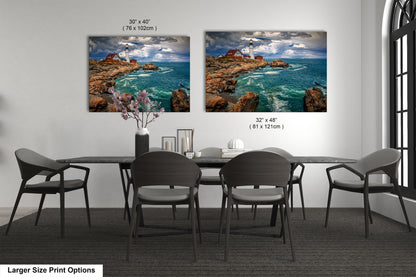 a dining room table with four chairs and two pictures on the wall