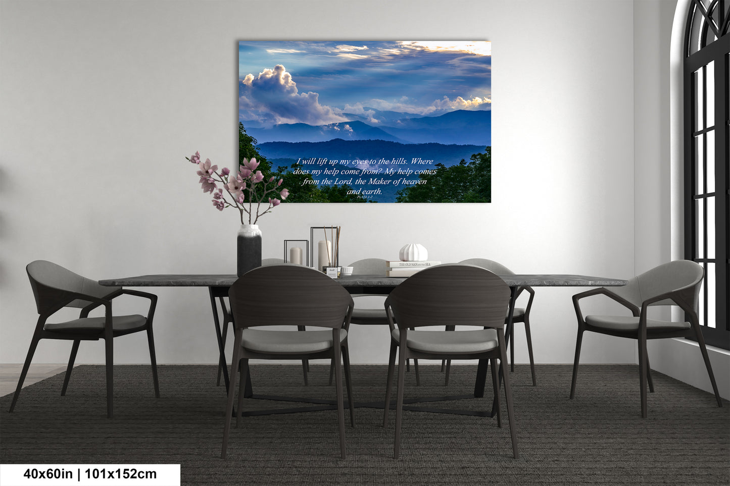 a dining room table with chairs and a painting on the wall