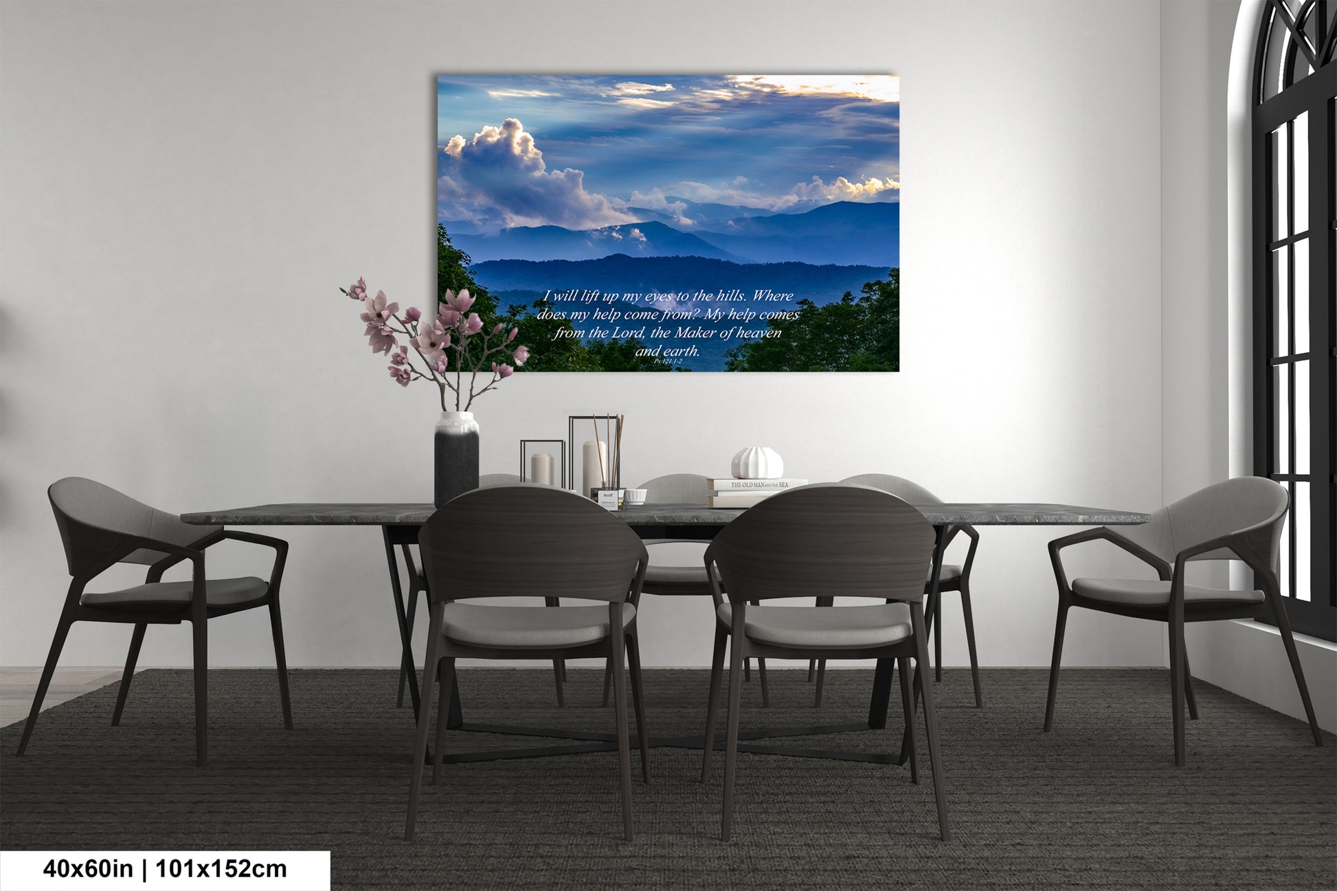 a dining room table with chairs and a painting on the wall