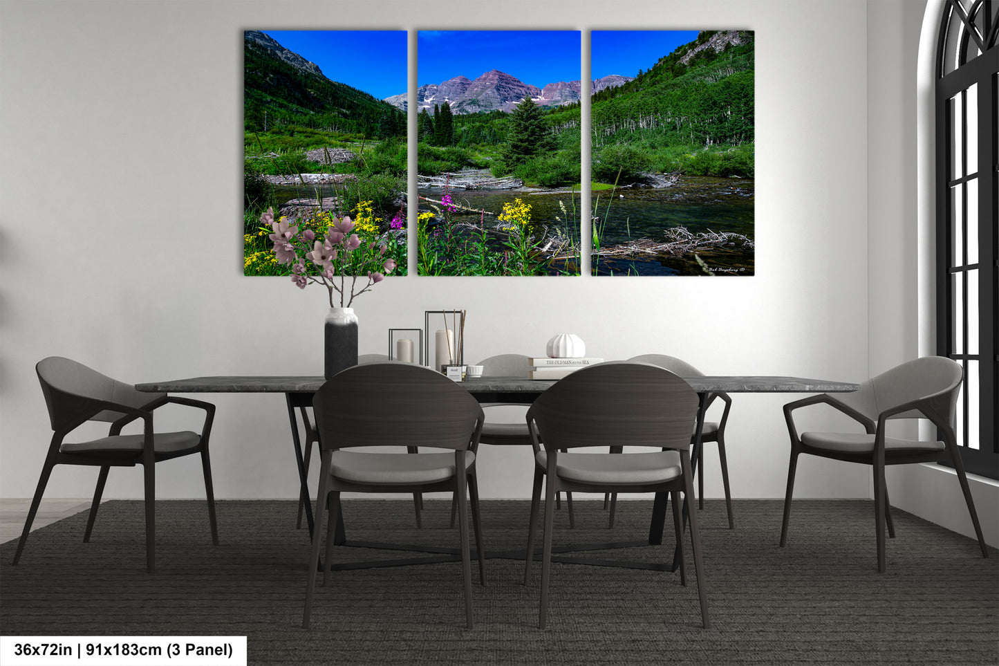 a dining room table with four chairs and a painting on the wall