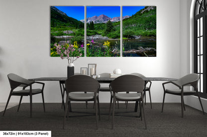 a dining room table with four chairs and a painting on the wall
