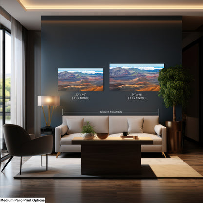 a modern living room with a large painting of a desert landscape hanging on the wall above a sofa and a coffee table.