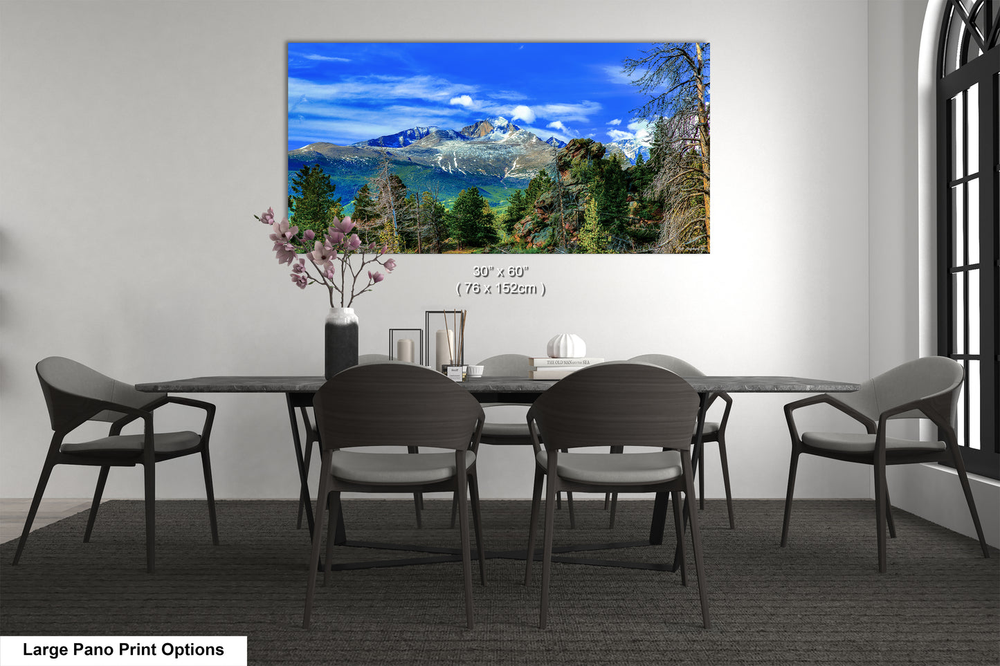 a dining room table with chairs and a painting on the wall