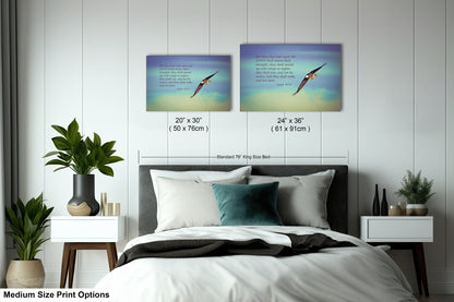 a bed with a white comforter and two pictures on the wall above it