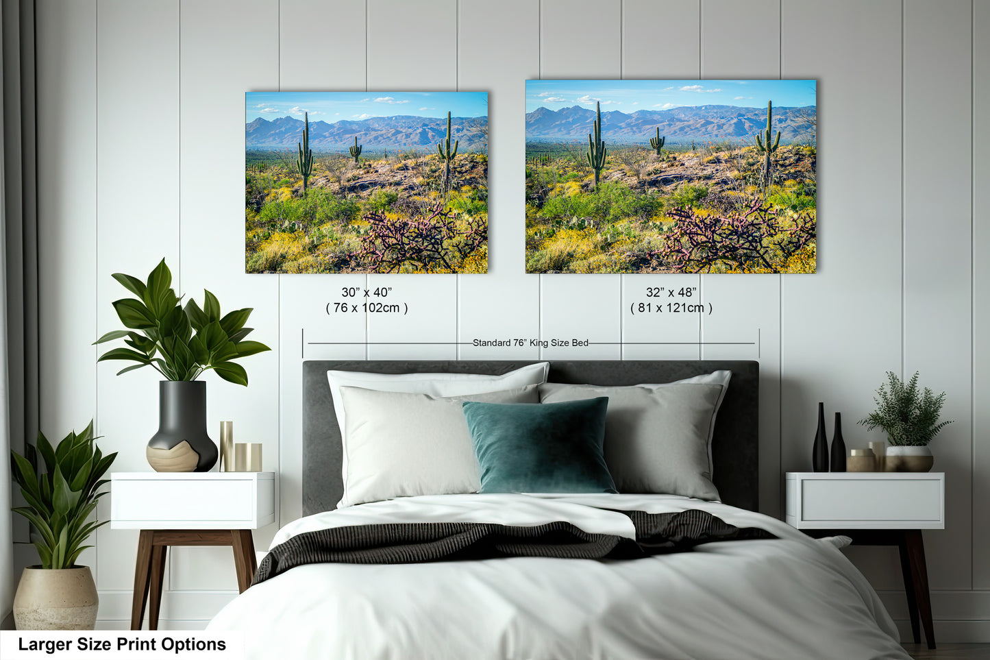 a bedroom with two framed landscape photographs hanging on the wall above a bed. The photographs depict a desert scene with mountains in the background.