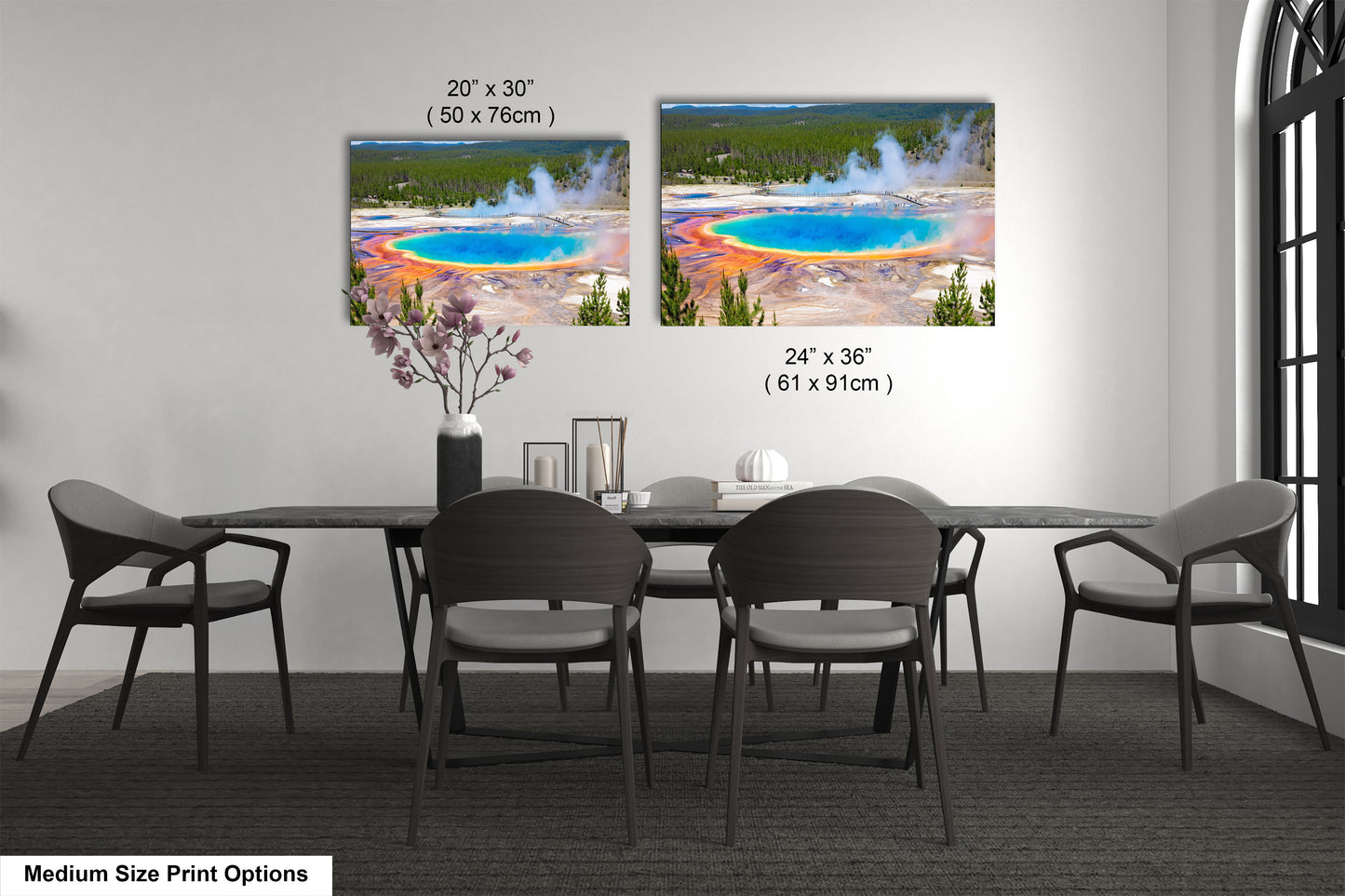 a dining room table with four chairs and a vase of flowers