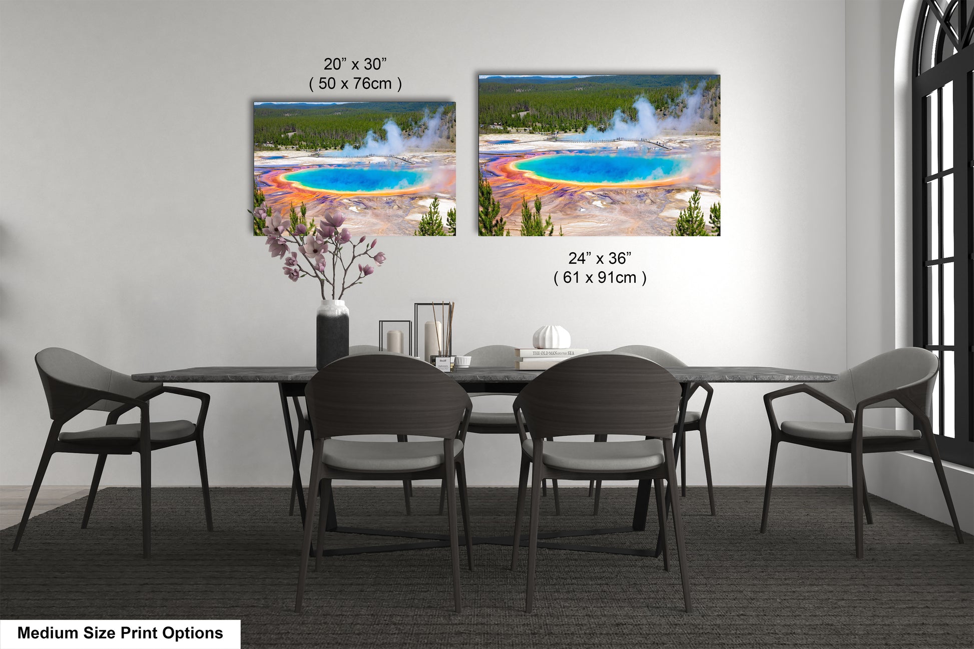 a dining room table with four chairs and a vase of flowers