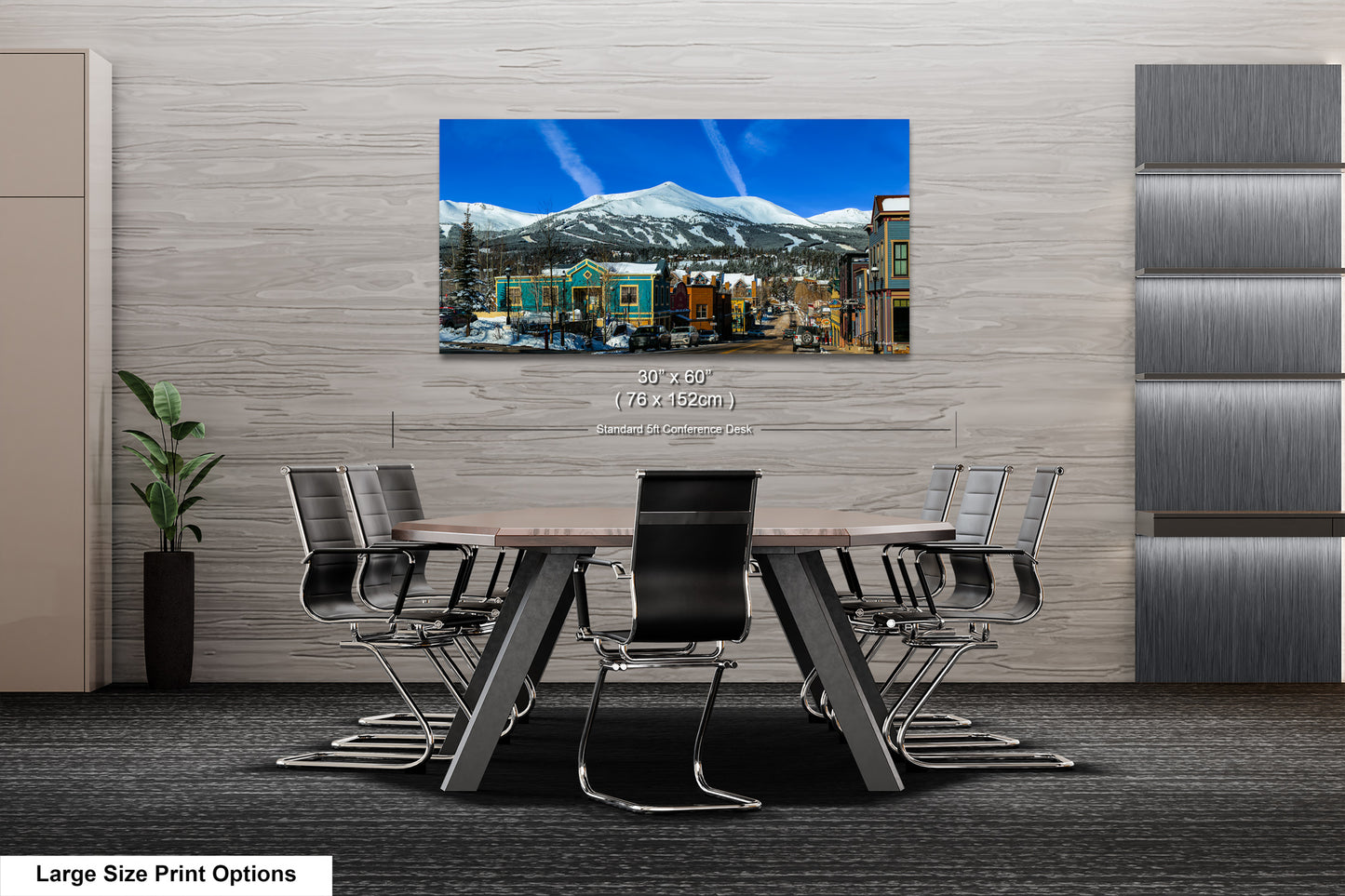 a dining room table with a painting of a mountain in the background